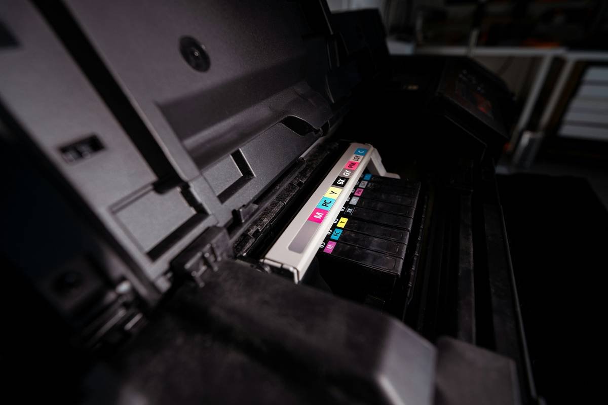 Close-up of technician performing vulnerability scanning for printers using CLI tools